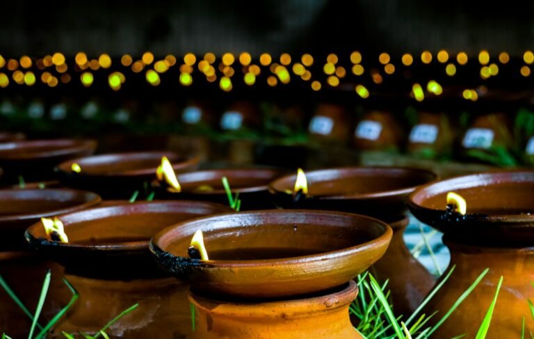Rows of lit oil lamps for Karthigai Deepam