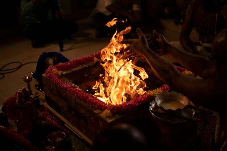 Priest tending the sacred fire, as in the homam at a Tamil wedding